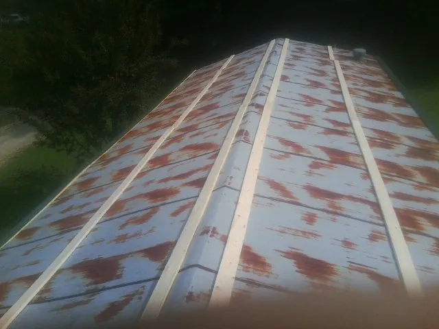 Rusted metal roof panels with new wood purlins before replacement — Storm Damage Roof Repair in South Amboy by Roofing Brothers