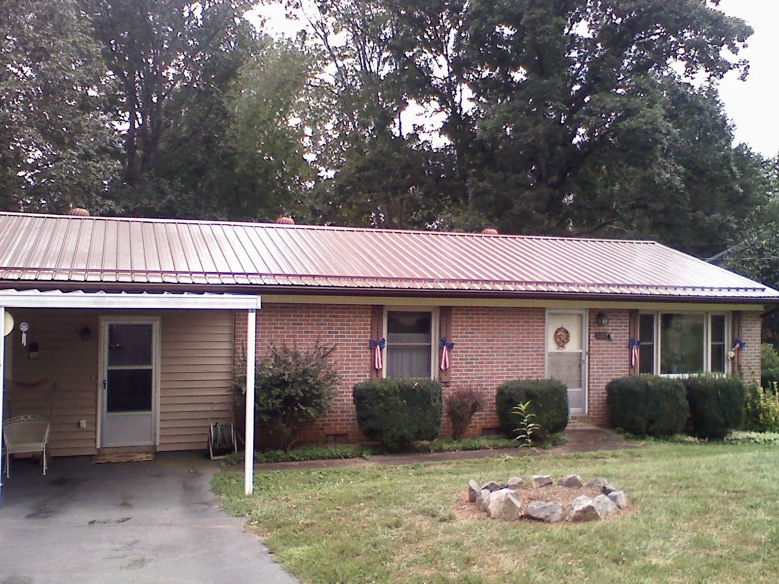 Bronze metal roof and carport on a brick ranch home — Roof Repair work by our crew in South Amboy