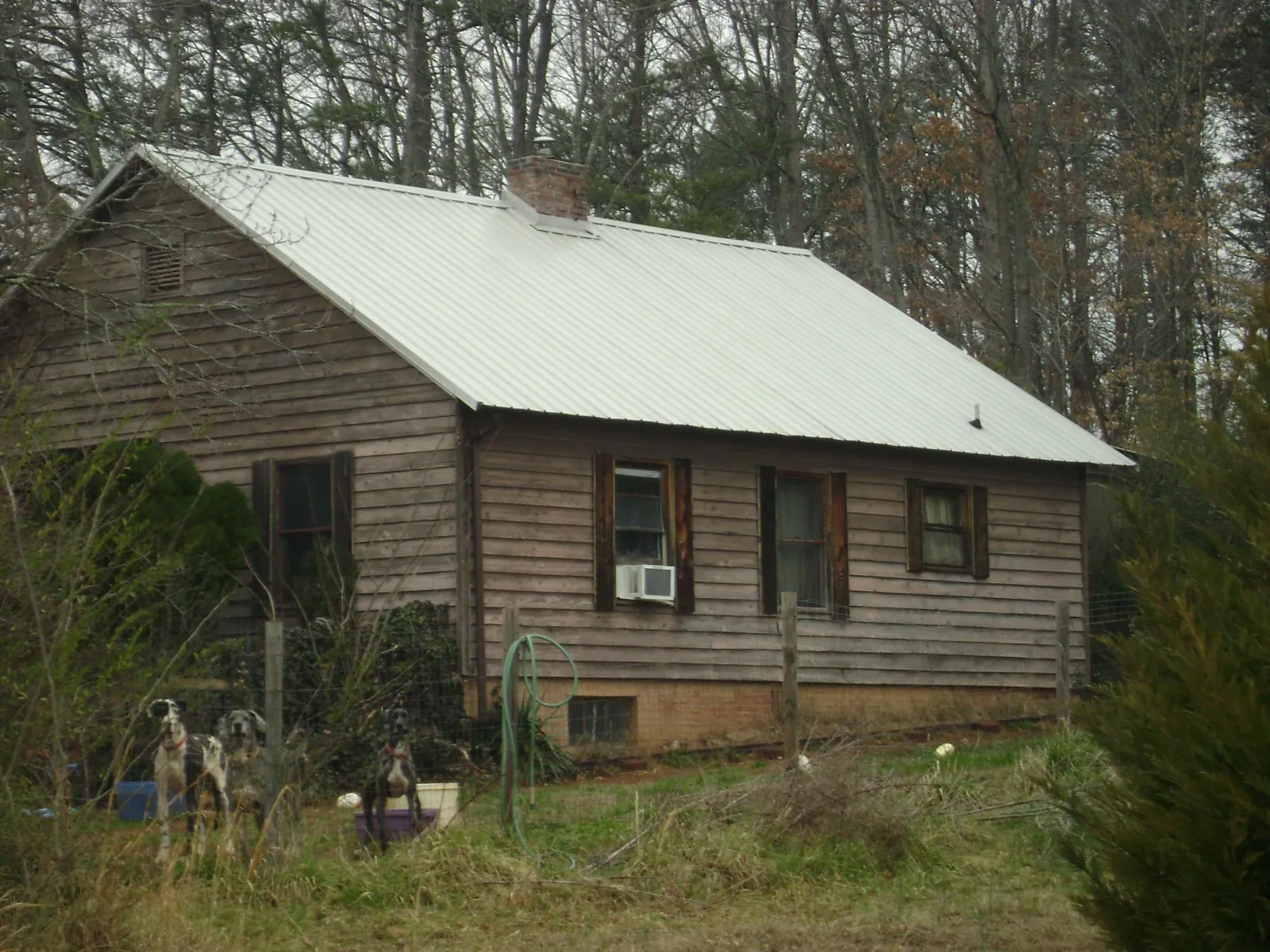 White metal roof on an old wood sided farmhouse, from a Metal Roof Installation job in South Amboy